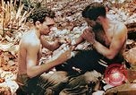 Image of Marine renders first aid to wounded buddy Saipan Northern Mariana Islands, 1944, second 9 stock footage video 65675028048