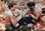 Image of Marine renders first aid to wounded buddy Saipan Northern Mariana Islands, 1944, second 10 stock footage video 65675028048