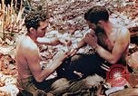 Image of Marine renders first aid to wounded buddy Saipan Northern Mariana Islands, 1944, second 11 stock footage video 65675028048