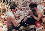 Image of Marine renders first aid to wounded buddy Saipan Northern Mariana Islands, 1944, second 13 stock footage video 65675028048
