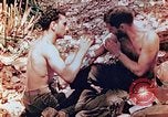 Image of Marine renders first aid to wounded buddy Saipan Northern Mariana Islands, 1944, second 14 stock footage video 65675028048