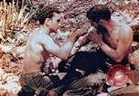 Image of Marine renders first aid to wounded buddy Saipan Northern Mariana Islands, 1944, second 15 stock footage video 65675028048