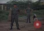 Image of sentry dog patrolling field Tan Son Nhut Air Force Base Vietnam, 1965, second 18 stock footage video 65675028506