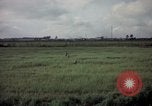 Image of sentry dog patrolling field Tan Son Nhut Air Force Base Vietnam, 1965, second 38 stock footage video 65675028506