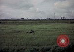 Image of sentry dog patrolling field Tan Son Nhut Air Force Base Vietnam, 1965, second 50 stock footage video 65675028506