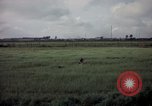 Image of sentry dog patrolling field Tan Son Nhut Air Force Base Vietnam, 1965, second 56 stock footage video 65675028506