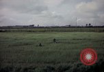Image of sentry dog patrolling field Tan Son Nhut Air Force Base Vietnam, 1965, second 58 stock footage video 65675028506