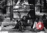 Image of Man sings and plays a saranqi at a temple India, 1953, second 1 stock footage video 65675028606