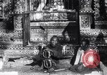 Image of Man sings and plays a saranqi at a temple India, 1953, second 3 stock footage video 65675028606