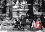 Image of Man sings and plays a saranqi at a temple India, 1953, second 4 stock footage video 65675028606
