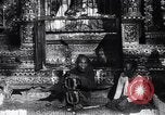 Image of Man sings and plays a saranqi at a temple India, 1953, second 5 stock footage video 65675028606