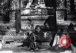 Image of Man sings and plays a saranqi at a temple India, 1953, second 6 stock footage video 65675028606