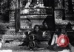 Image of Man sings and plays a saranqi at a temple India, 1953, second 7 stock footage video 65675028606