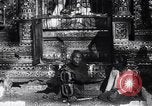 Image of Man sings and plays a saranqi at a temple India, 1953, second 8 stock footage video 65675028606