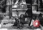 Image of Man sings and plays a saranqi at a temple India, 1953, second 9 stock footage video 65675028606