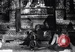 Image of Man sings and plays a saranqi at a temple India, 1953, second 10 stock footage video 65675028606