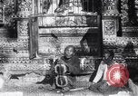 Image of Man sings and plays a saranqi at a temple India, 1953, second 16 stock footage video 65675028606