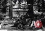 Image of Man sings and plays a saranqi at a temple India, 1953, second 20 stock footage video 65675028606