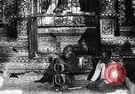 Image of Man sings and plays a saranqi at a temple India, 1953, second 21 stock footage video 65675028606