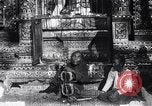 Image of Man sings and plays a saranqi at a temple India, 1953, second 22 stock footage video 65675028606