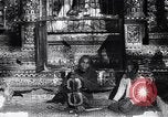 Image of Man sings and plays a saranqi at a temple India, 1953, second 23 stock footage video 65675028606