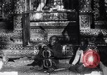 Image of Man sings and plays a saranqi at a temple India, 1953, second 25 stock footage video 65675028606
