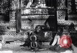Image of Man sings and plays a saranqi at a temple India, 1953, second 28 stock footage video 65675028606