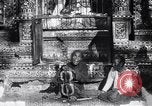 Image of Man sings and plays a saranqi at a temple India, 1953, second 30 stock footage video 65675028606