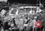 Image of Men digging clay from a river bank India, 1953, second 7 stock footage video 65675028607