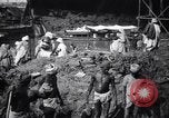 Image of Men digging clay from a river bank India, 1953, second 8 stock footage video 65675028607