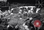 Image of Men digging clay from a river bank India, 1953, second 12 stock footage video 65675028607