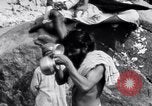 Image of Hindu pilgrims bathe while on journey to Ganges river source India, 1939, second 12 stock footage video 65675028617