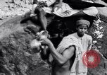 Image of Hindu pilgrims bathe while on journey to Ganges river source India, 1939, second 14 stock footage video 65675028617