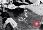 Image of Hindu pilgrims bathe while on journey to Ganges river source India, 1939, second 20 stock footage video 65675028617