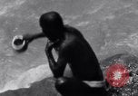 Image of Hindu pilgrims bathe while on journey to Ganges river source India, 1939, second 26 stock footage video 65675028617