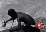Image of Hindu pilgrims bathe while on journey to Ganges river source India, 1939, second 27 stock footage video 65675028617