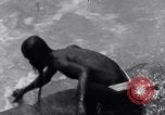 Image of Hindu pilgrims bathe while on journey to Ganges river source India, 1939, second 30 stock footage video 65675028617