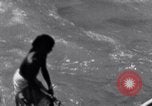 Image of Hindu pilgrims bathe while on journey to Ganges river source India, 1939, second 45 stock footage video 65675028617