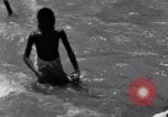 Image of Hindu pilgrims bathe while on journey to Ganges river source India, 1939, second 49 stock footage video 65675028617