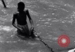 Image of Hindu pilgrims bathe while on journey to Ganges river source India, 1939, second 50 stock footage video 65675028617