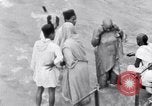 Image of Hindu pilgrims bathe while on journey to Ganges river source India, 1939, second 51 stock footage video 65675028617
