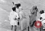 Image of Hindu pilgrims bathe while on journey to Ganges river source India, 1939, second 52 stock footage video 65675028617
