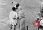Image of Hindu pilgrims bathe while on journey to Ganges river source India, 1939, second 54 stock footage video 65675028617