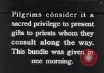 Image of Hindu pilgrims giving gifts to priests during their pilgrimage India, 1939, second 1 stock footage video 65675028618