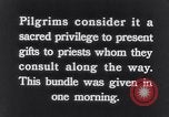 Image of Hindu pilgrims giving gifts to priests during their pilgrimage India, 1939, second 3 stock footage video 65675028618
