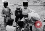Image of Hindu pilgrims giving gifts to priests during their pilgrimage India, 1939, second 56 stock footage video 65675028618
