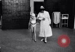 Immagine di Crippled bambino con un infermiere United States USA, 1920, secondo 14 filmato di repertorio 65675028690