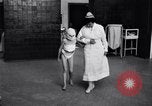 Immagine di Crippled bambino con un infermiere United States USA, 1920, secondo 15 filmato di repertorio 65675028690