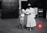 Immagine di Crippled bambino con un infermiere United States USA, 1920, secondo 16 filmato di repertorio 65675028690