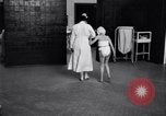 Immagine di Crippled bambino con un infermiere United States USA, 1920, secondo 25 filmato di repertorio 65675028690